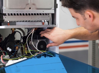 A man checking the wiring connections