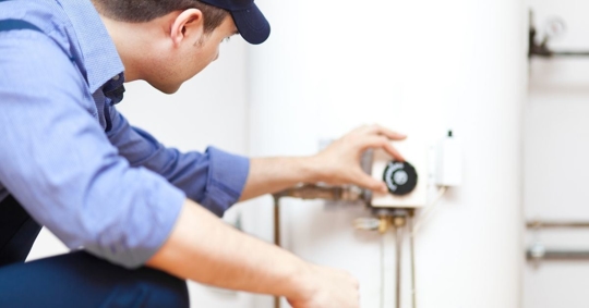 Repair person checking water heater