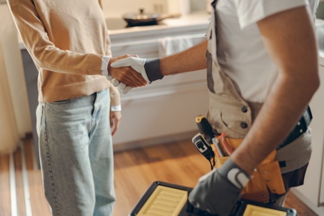 serviceman and homeowner shaking hands