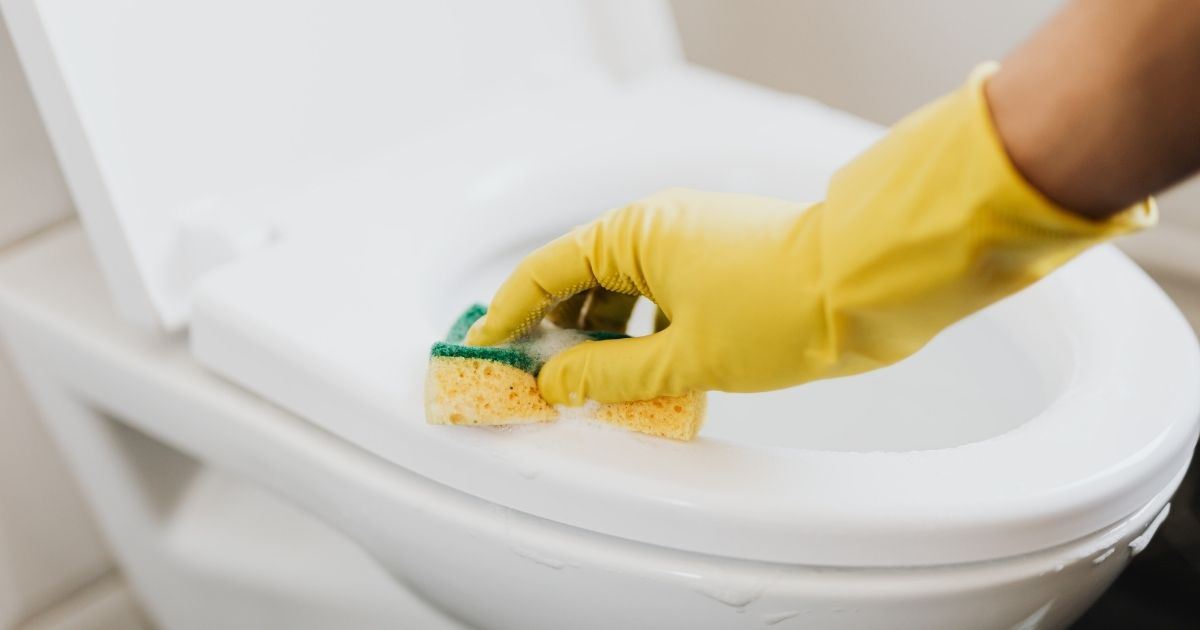 Close up of a toilet being cleaned